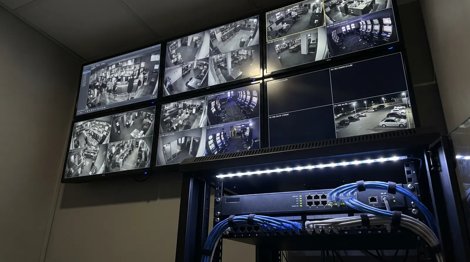 Wall of CCTV monitors above a network video recorder rack